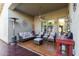 Comfortable covered patio featuring stylish furniture, ceiling fan, and textured concrete flooring at 3823 S 101St Dr, Tolleson, AZ 85353