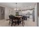 Cozy dining area with modern light fixtures, a full kitchen, and easy access to the living space at 3823 S 101St Dr, Tolleson, AZ 85353