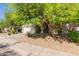 Attractive single-level home with a neat front yard, mature trees, and a welcoming entrance at 3823 S 101St Dr, Tolleson, AZ 85353