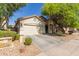 Well-kept single-story home with a two-car garage and a simple, desert-style landscaped front yard at 3823 S 101St Dr, Tolleson, AZ 85353
