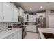 Well-equipped kitchen featuring white cabinets, stainless steel appliances, and stylish backsplash at 3823 S 101St Dr, Tolleson, AZ 85353