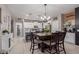Bright kitchen and dining area featuring white cabinets and a spacious island with seating at 3823 S 101St Dr, Tolleson, AZ 85353