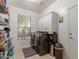Well-organized laundry room with modern washer and dryer, cabinets, and natural light at 3823 S 101St Dr, Tolleson, AZ 85353