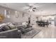 Open floor plan with a living room area featuring a large sectional sofa connecting to a dining area at 3823 S 101St Dr, Tolleson, AZ 85353