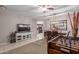 Open-concept living space with tile and carpet, a modern TV console, and a dining area at 3823 S 101St Dr, Tolleson, AZ 85353