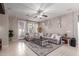 Bright and airy living room with a large sofa, decorative rug, and neutral color scheme at 3823 S 101St Dr, Tolleson, AZ 85353