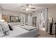 Comfortable main bedroom showcasing a plush bed, soft textures, and a glimpse into the ensuite at 3823 S 101St Dr, Tolleson, AZ 85353
