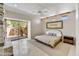 Neutral bedroom with outdoor access, stone fireplace and tiled floors at 39032 N 101St Way, Scottsdale, AZ 85262