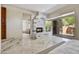 Bedroom boasting stone fireplace, neutral color palette and access to outdoor space at 39032 N 101St Way, Scottsdale, AZ 85262
