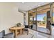 Breakfast nook with a wooden table, desert views, and access to the patio through sliding glass doors at 39032 N 101St Way, Scottsdale, AZ 85262