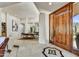Spacious entryway featuring travertine flooring, a decorative inlaid design, and views of the dining room at 39032 N 101St Way, Scottsdale, AZ 85262