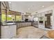 Modern kitchen featuring stainless steel appliances, custom cabinetry, a wine refrigerator, and a granite countertop at 39032 N 101St Way, Scottsdale, AZ 85262