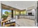Bright kitchen with stainless steel appliances, sleek cabinets, black countertops, and a large window with a desert view at 39032 N 101St Way, Scottsdale, AZ 85262