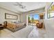 Spacious main bedroom with outdoor access, ceiling fan and tiled floors at 39032 N 101St Way, Scottsdale, AZ 85262