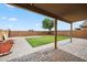 Covered patio overlooking backyard with artificial turf and paver patio at 4587 E Silverbell Rd, San Tan Valley, AZ 85143
