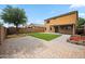 Expansive backyard with pavers, a patio, green grass, and block wall fencing at 4587 E Silverbell Rd, San Tan Valley, AZ 85143