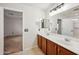 Bathroom featuring double sinks, wood cabinets, and a large mirror above the vanity at 4587 E Silverbell Rd, San Tan Valley, AZ 85143
