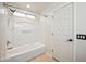 Bathroom with a white tub and shower combination and a small window above at 4587 E Silverbell Rd, San Tan Valley, AZ 85143
