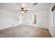 A bedroom with white walls, a ceiling fan, and a window with horizontal blinds at 4587 E Silverbell Rd, San Tan Valley, AZ 85143