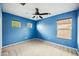 Blue bedroom with three windows and neutral carpet at 4587 E Silverbell Rd, San Tan Valley, AZ 85143