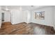 Bright living room featuring wood-look floors, neutral walls, and ample natural light through the window at 4587 E Silverbell Rd, San Tan Valley, AZ 85143