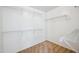 Walk-in closet with white shelving and beige carpet at 4587 E Silverbell Rd, San Tan Valley, AZ 85143