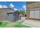 Backyard view of gray shed on a lawn with a walkway and partial view of the house at 4647 E County Down Dr, Chandler, AZ 85249