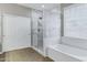 Bright bathroom featuring marble-look shower, sliding glass door and bathtub at 4647 E County Down Dr, Chandler, AZ 85249