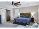 Beautiful bedroom featuring wood accent headboard, ceiling fan and sliding barn door at 4647 E County Down Dr, Chandler, AZ 85249