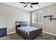 Cozy bedroom with a ceiling fan, shuttered window, and furnishings including a queen bed and nightstand at 4647 E County Down Dr, Chandler, AZ 85249