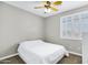 Bright bedroom featuring neutral walls, shuttered window, and ceiling fan over a neatly made bed at 4647 E County Down Dr, Chandler, AZ 85249