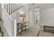 Inviting entryway features tile floors, staircase with white railing, and a decorative wooden table at 4647 E County Down Dr, Chandler, AZ 85249