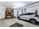 Clean garage with an electric car, organized shelving, and bicycle racks at 4647 E County Down Dr, Chandler, AZ 85249