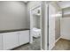 Hallway with cabinetry, open doorways, and views to an adjacent bedroom and bathroom at 4647 E County Down Dr, Chandler, AZ 85249