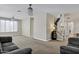 Open living room featuring neutral tones, a staircase, and ample natural light at 4647 E County Down Dr, Chandler, AZ 85249