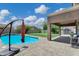 View of the pool and shaded patio, perfect for outdoor entertaining and relaxation at 4647 E County Down Dr, Chandler, AZ 85249