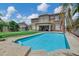 Inviting backyard with a sparkling pool and view of the two-story home at 4647 E County Down Dr, Chandler, AZ 85249