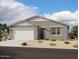 A charming single-story home with neutral stucco, a two-car garage, and a well-maintained desert landscape at 46819 W Old Timer Rd, Maricopa, AZ 85139