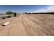 Vacant lot ready for construction with cinderblock wall at rear and utilities connection at 46819 W Old Timer Rd, Maricopa, AZ 85139