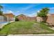 Spacious backyard with grassy lawn, brick wall, and partial view of the pool at 5220 W Desert Ln, Laveen, AZ 85339