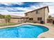 The home features a refreshing backyard pool with a patio area and a view of the house, perfect for outdoor entertaining at 5220 W Desert Ln, Laveen, AZ 85339