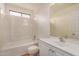 Bathroom featuring tub-shower combo, toilet, and sink with ample counter space at 5220 W Desert Ln, Laveen, AZ 85339