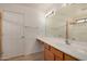 Bathroom featuring a single sink vanity, a large mirror, and a shower at 5220 W Desert Ln, Laveen, AZ 85339