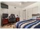 This bedroom features a ceiling fan, tile flooring and a desk at 5220 W Desert Ln, Laveen, AZ 85339