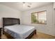 Bedroom with a ceiling fan, window with blinds and a dark colored bed frame at 5220 W Desert Ln, Laveen, AZ 85339
