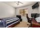 Bedroom featuring a ceiling fan, tile flooring, wooden desk and a window with blinds at 5220 W Desert Ln, Laveen, AZ 85339
