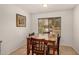Cozy dining room with tile floors, a window, and a wooden table with seating for four at 5220 W Desert Ln, Laveen, AZ 85339