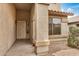 Covered front porch with security door and a large front window at 5220 W Desert Ln, Laveen, AZ 85339