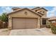 Beige two-story home with a two-car garage and desert landscaping at 5220 W Desert Ln, Laveen, AZ 85339