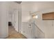 Bright hallway with tiled floors, white railing, and hanging light fixture at 5220 W Desert Ln, Laveen, AZ 85339